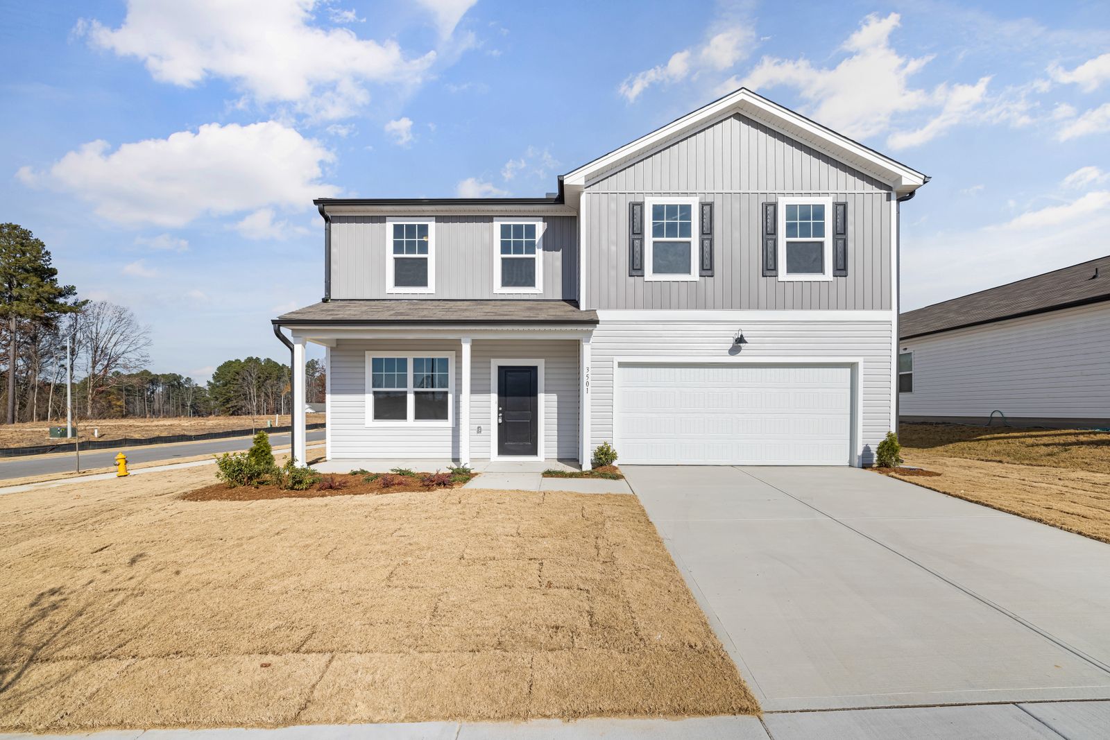 Driveway and home exterior shown clean